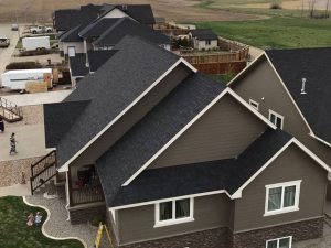 Roofing completed for multiple houses in a new development community. Black shingles.