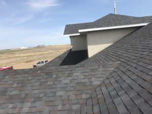 Close up of a multi-tone grey shingle roof.